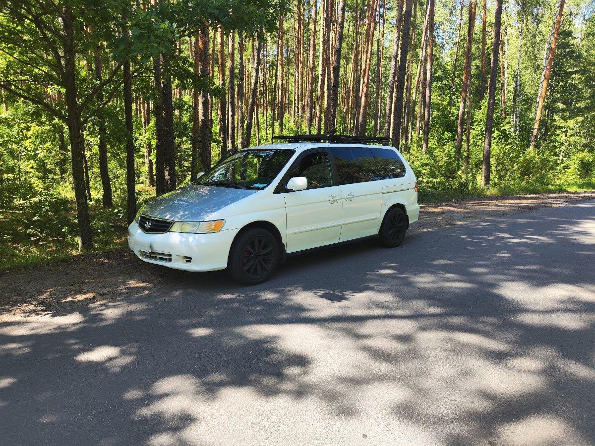 Honda Odyssey front view with modified aftermarket accessories and camping setup